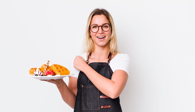 Smiling person holding a plate of food